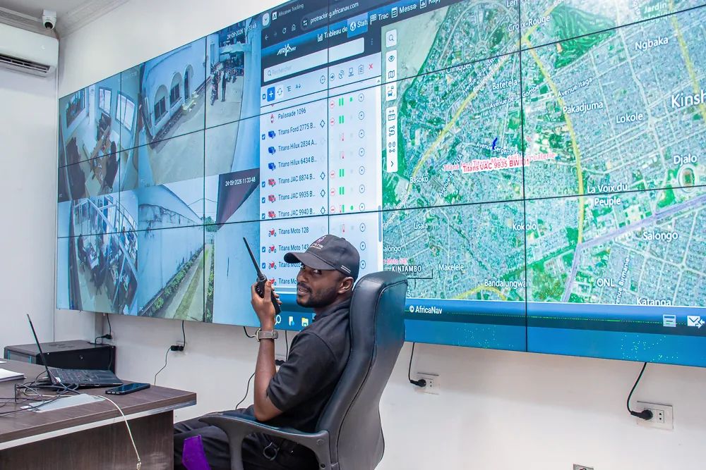 Titans operator seated at the monitoring desk with CCTV and vehicle tracking screens