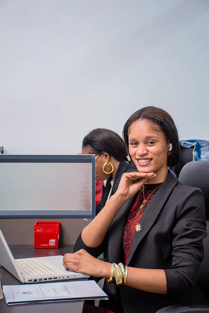 Titans team member at her desk with a laptop