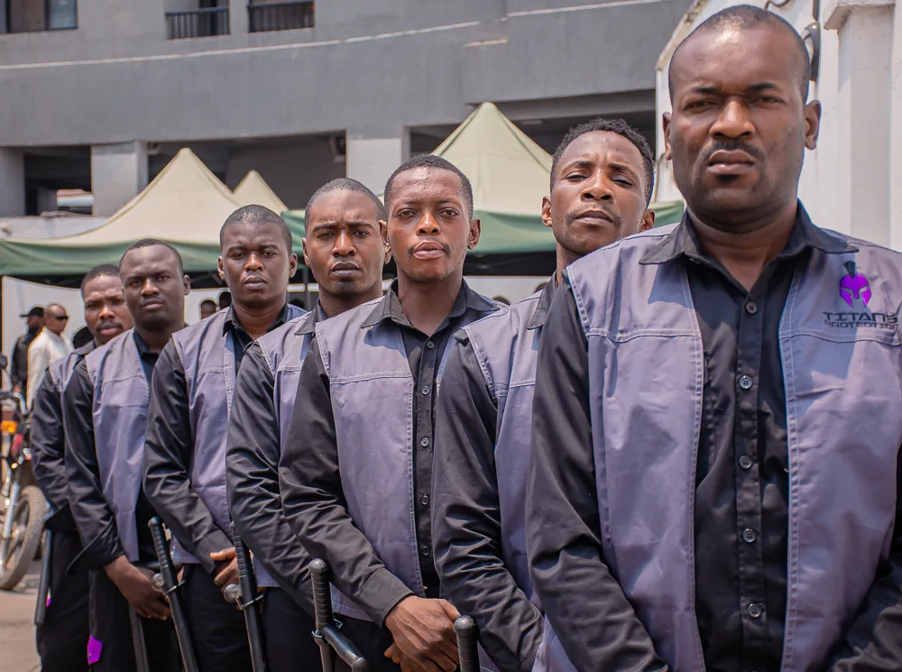 Titans guards in uniform standing together outside a building