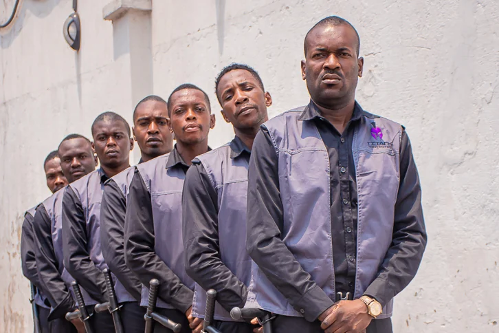 Titans guards in uniform standing together outside a building