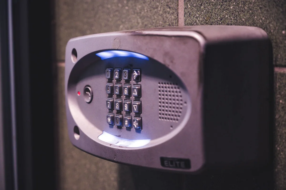 Exterior security entry keypad with blue illuminated controls