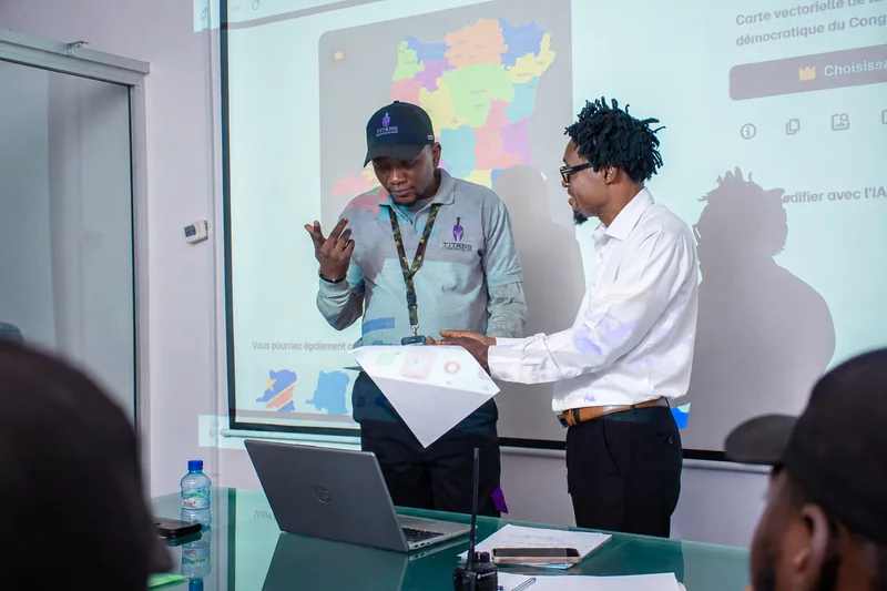 Two team members discussing documents during a Titans planning session